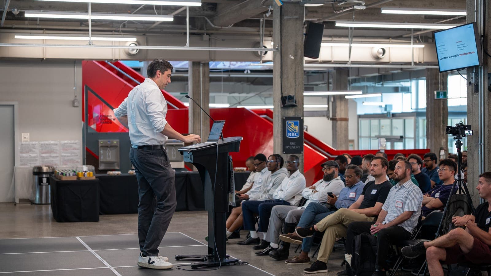 A founder presenting their project on stage at a Spark showcase night