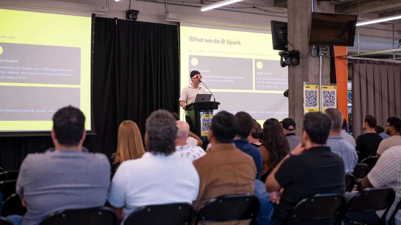 A founder presenting on stage at a Spark event
