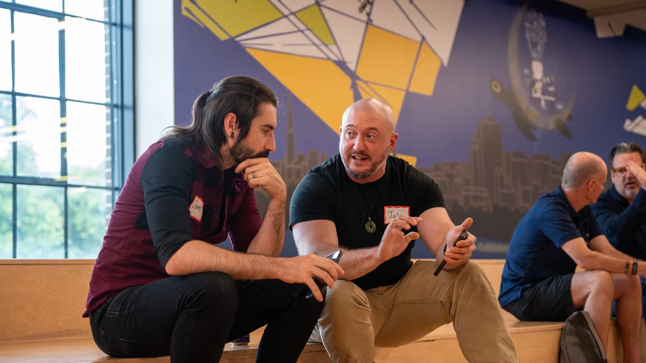Two attendees talking at a Spark event